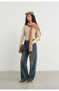 Full length view of a soft beige knitted cardigan paired with a gradient brown scarf