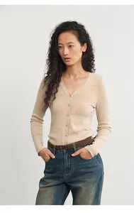 Elegant slim fit beige knitted cardigan with V-neck and buttons worn by Asian model