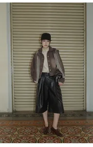 Street style look featuring a brown gradient washed denim jacket and wide-leg pants