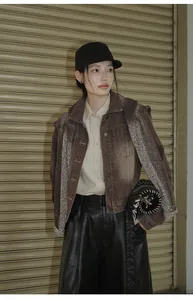 Model wearing a brown gradient wash short denim jacket with wide-leg leather pants