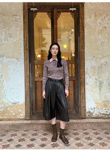 Asian model wearing high-waist wide-leg black PU leather culottes for autumn streetwear