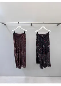 Detail view showing retro floral bias-cut fishtail maxi skirts in black and brown.