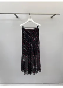 Vintage floral printed midi skirt with bias-cut fishtail hem elegantly on a hanger