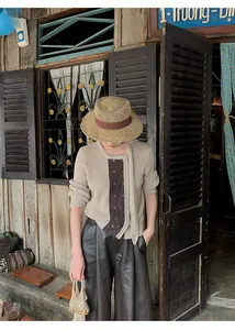 Model wearing stylish high-waisted soft PU leather wide-leg culottes in rustic setting