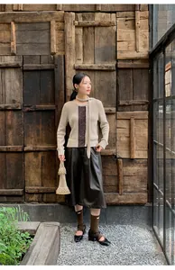 High-waisted wide-leg faux leather culottes for women in a rustic street style setting