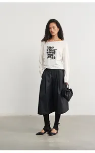 Stylish black high-waisted PU leather wide-leg culottes paired with white graphic tee shirt