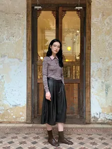 Elegant high-waisted wide-leg faux leather culottes for women in vintage setting