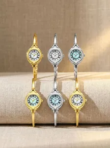 Six elegant GEDI bangle watches displayed on a textured neutral fabric surface