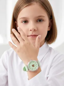 Detail view of a green Gedi cartoon bear watch on a child's wrist with soft silicone strap.