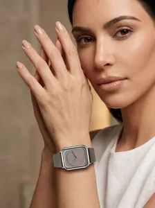 Close-up of elegant women's square quartz watch with grey leather strap and minimalist dial