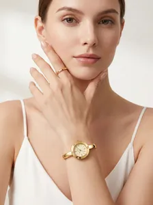 Elegant gold bangle watch for women featuring Roman numerals and diamond accents