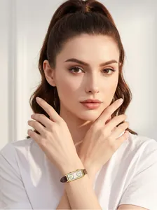 Model wearing a vintage rectangular watch with dual dials and brown leather strap