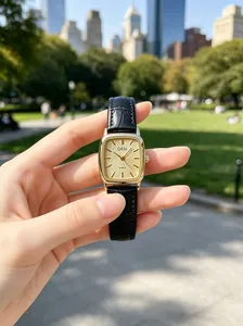 Close-up of GEDI vintage gold square watch with textured dial and black leather strap