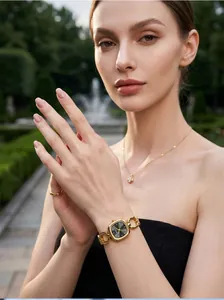 Detailed view of GEDI gold square dial watch with hollow chain strap on a model's wrist