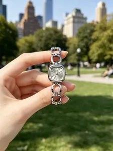 Detailed view of an elegant women's quartz watch with a square dial and hollow chain strap