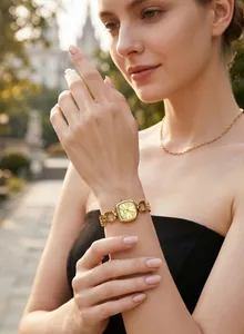 Elegant GEDI women's gold square watch with a hollow chain strap worn by a model