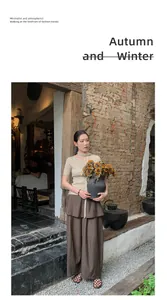 Elegant high-waisted wide-leg trousers for autumn with vintage rustic brick background