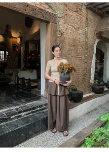 Old money style fake two-piece wide-leg pants with a high waist in a rustic setting