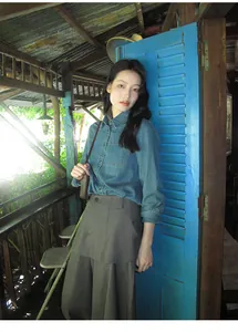 Layered wide-leg skort and denim shirt outfit detail in vintage setting