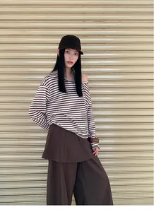 Stylish two-piece set featuring a brown striped long-sleeve top and layered wide-leg pants.