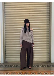 Brown fake two-piece wide leg trousers shown in a stylish street lifestyle setting