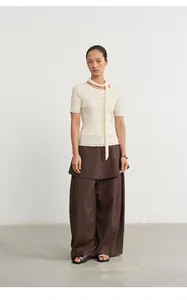 Model wearing brown two-piece style wide leg skirt-pants with high waist design