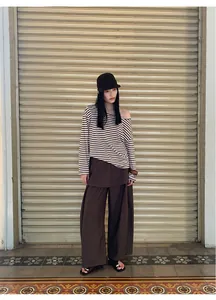 Model wearing a brown striped long-sleeve top and matching wide-leg trousers