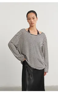 Front view of a striped long-sleeve cover-up with a black halter-neck two-piece set