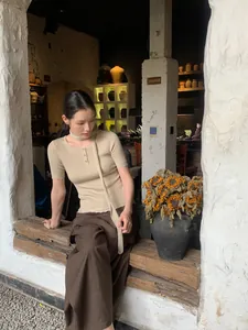 Elegant old money style high-waisted wide-leg brown skort with beige ribbed top