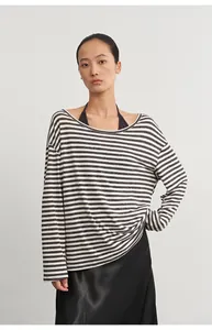 Close-up of a striped long-sleeve cover-up layered over a black halter neck camisole