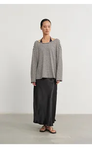 Detailed look at a striped long-sleeve cover-up with a detachable black camisole set.