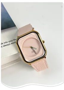 Close-up detail of a luxury Gedi square watch featuring a pink leather strap and gold case