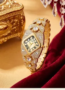 Close-up of GEDI gold bracelet watch for women with full diamond pavé and quartz movement.