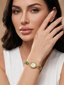 Close-up of GEDI vintage gold watch with green stone bracelet on a female model's wrist