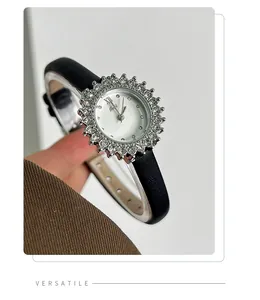 Close-up of elegant rhinestone sunflower watch with black leather strap for women