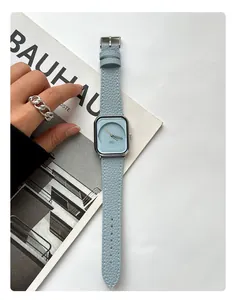 A minimalist square ladies watch with light blue leather strap on Bauhaus magazine