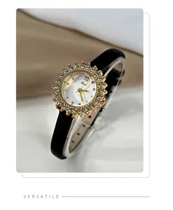Close-up of women's gold quartz watch with sunflower rhinestone bezel and black strap