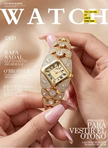 Close-up of a luxury gold rhinestone watch held by a hand in magazine layout