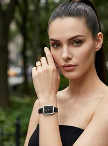 Close-up of a woman wearing a GEDI retro square quartz watch with a black leather strap