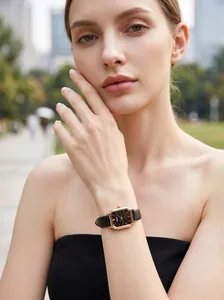 Detail of GEDI women's quartz watch with rose gold rectangular case and black leather strap.