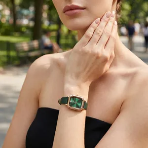GEDI vintage rectangular watch with green dial and rose gold case on model's wrist