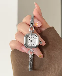 Close-up of a square silver quartz watch with rhinestone lugs on a lady's hand