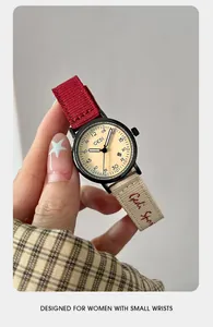 Detailed view of the GEDI quartz watch featuring stylish red and beige woven straps