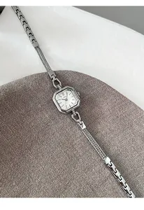 Close-up detail of a silver square women's quartz watch with elegant alloy mesh strap