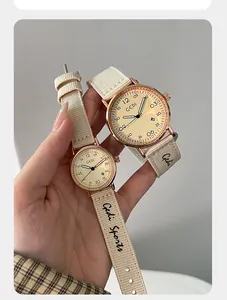 Detailed macro view of GEDI quartz watch featuring a cream nylon strap and rose gold finish