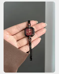 Close-up of elegant ladies square quartz watch with deep red dial and black mesh strap