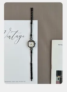 Vintage square black alloy quartz watch for women shown on a minimalist white card.