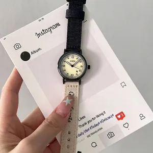 Stylish minimalist cream dial quartz watch with black and beige dual-tone nylon strap for women