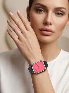 Elegant ladies square quartz watch with black leather strap and coral dial on wrist
