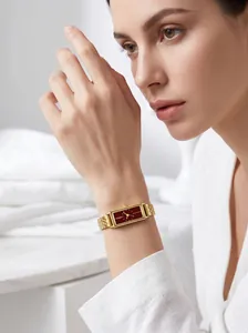 Close-up of the elegant Guou gold rectangular watch featuring a burgundy dial on a female wrist